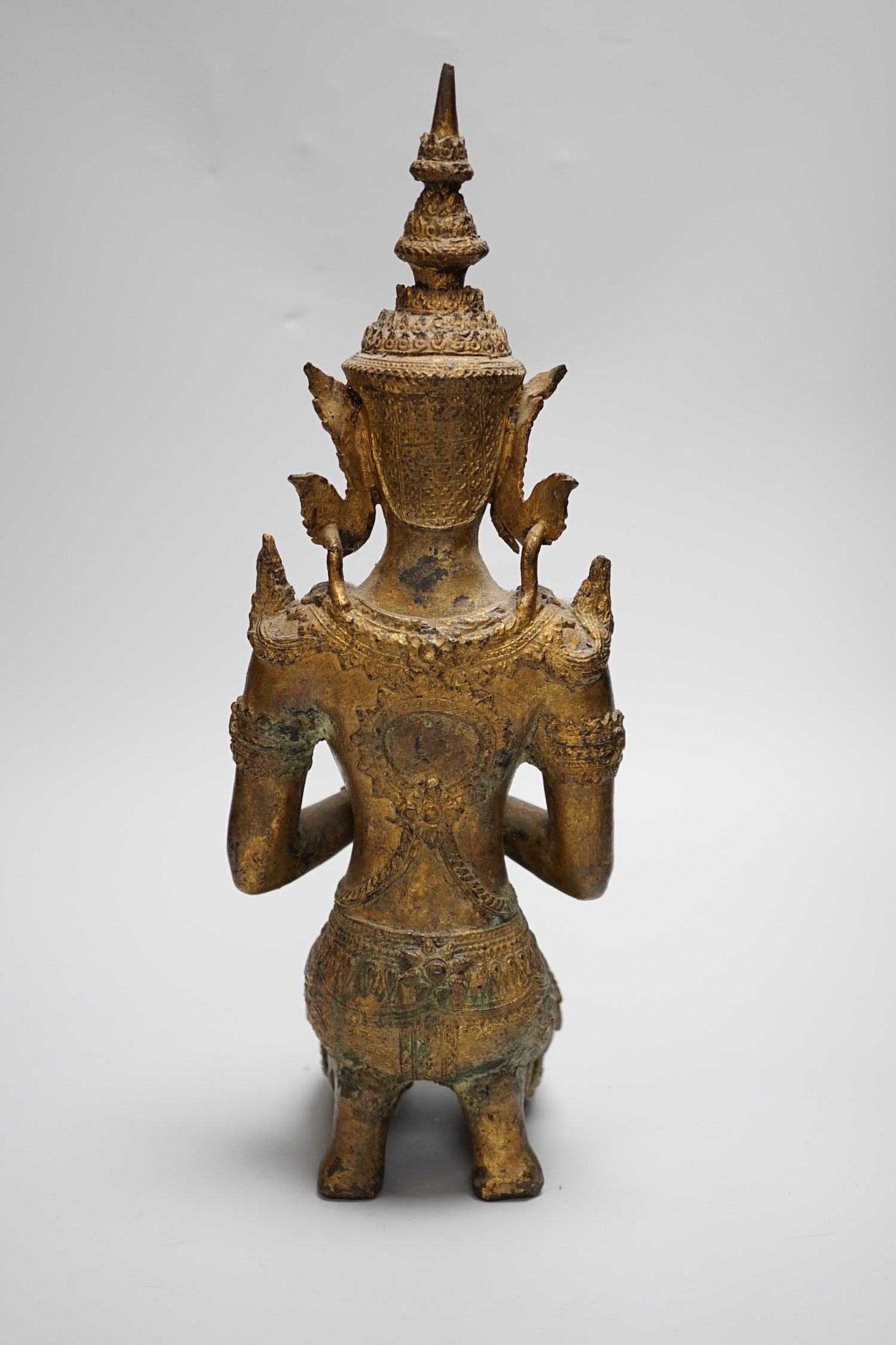 A Thai kneeling Buddha in gilt bronze, 34cm